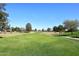 Expansive view of the lush green golf course, offering a picturesque and active lifestyle at 9512 E Kilarea Ave, Mesa, AZ 85209