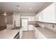 Spacious kitchen featuring bright white cabinetry, a kitchen island, and an open layout at 9512 E Kilarea Ave, Mesa, AZ 85209