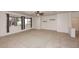 Bright living room with tile flooring, carpet, ceiling fan, and two windows with dark curtains at 9512 E Kilarea Ave, Mesa, AZ 85209