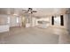 Open-concept living space with tile flooring, a kitchen, and access to the backyard via sliding glass doors at 9512 E Kilarea Ave, Mesa, AZ 85209