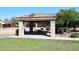 Covered picnic area with solar panels on the roof, providing a comfortable place to relax and enjoy a meal outdoors at 9512 E Kilarea Ave, Mesa, AZ 85209