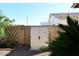 Durable outdoor storage shed nestled behind a brick wall and surrounded by greenery, providing secure storage at 9512 E Kilarea Ave, Mesa, AZ 85209