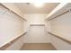 Spacious walk-in closet with custom shelves and ample storage space at 9512 E Kilarea Ave, Mesa, AZ 85209