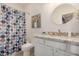 The bathroom has a decorative shower curtain, vanity, and a round mirror at 955 E Knox Rd # 224, Chandler, AZ 85225