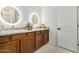 Bathroom with double vanity featuring decorative mirrors, wood cabinets and tile flooring at 955 E Knox Rd # 224, Chandler, AZ 85225
