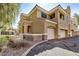 Two-story home featuring stucco siding, two car garages, and stone veneer accents for a luxurious aesthetic at 955 E Knox Rd # 224, Chandler, AZ 85225