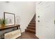Inviting foyer with hardwood floors, a staircase, decorative console table, and bright white walls at 955 E Knox Rd # 224, Chandler, AZ 85225