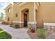 Home exterior featuring a covered front door with an arched entry, stone accents, and decorative plants at 955 E Knox Rd # 224, Chandler, AZ 85225