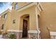 Home exterior featuring a covered front door with an arched entry, stone accents, and decorative plants at 955 E Knox Rd # 224, Chandler, AZ 85225