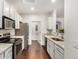 Modern kitchen featuring stainless steel appliances, white cabinets, granite counters, and hardwood floors at 955 E Knox Rd # 224, Chandler, AZ 85225