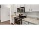 Bright kitchen showcasing modern stainless steel appliances and beautiful granite countertops at 955 E Knox Rd # 224, Chandler, AZ 85225