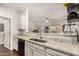 Well-lit kitchen featuring granite countertops, stainless steel sink, and sightlines into the living area at 955 E Knox Rd # 224, Chandler, AZ 85225