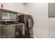 This laundry room has a newer washer and dryer, with a shelf above at 955 E Knox Rd # 224, Chandler, AZ 85225