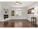 Spacious living room with a ceiling fan, a fireplace, hardwood floors and plenty of natural light at 955 E Knox Rd # 224, Chandler, AZ 85225
