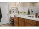 Primary bathroom with double sinks, wood cabinets, and bright natural light at 1024 E Frye Rd # 1093, Phoenix, AZ 85048