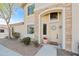 Inviting front entrance with stone accents, decorative wreath, and beautiful desert landscaping at 1024 E Frye Rd # 1093, Phoenix, AZ 85048