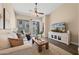 Cozy living room featuring a ceiling fan, sliding glass doors, and comfortable seating at 1024 E Frye Rd # 1093, Phoenix, AZ 85048