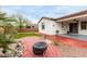 Landscaped backyard featuring brickwork, artificial grass, and a covered patio at 10320 E Tupelo Ave, Mesa, AZ 85212