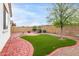 Spacious backyard with artificial turf, brickwork and desert landscaping at 10320 E Tupelo Ave, Mesa, AZ 85212