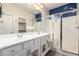 Bathroom boasting double sinks, white cabinets, and a glass-enclosed shower for a luxurious feel at 10320 E Tupelo Ave, Mesa, AZ 85212