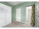 A bright bedroom with a door, closet, built-in storage, and carpeted floors at 10320 E Tupelo Ave, Mesa, AZ 85212