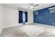 Bedroom with blue accent wall, ceiling fan, and wall-to-wall carpeting at 10320 E Tupelo Ave, Mesa, AZ 85212