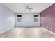 Spacious room featuring gray wood-look tile floors and a ceiling fan at 10320 E Tupelo Ave, Mesa, AZ 85212