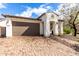 Charming single-Gathering home with a two-car garage and inviting front entrance, showcasing curb appeal at 10320 E Tupelo Ave, Mesa, AZ 85212