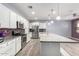 Modern kitchen featuring white cabinets, stainless steel appliances, an island, and stylish backsplash at 10320 E Tupelo Ave, Mesa, AZ 85212