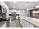 Open-concept kitchen featuring white cabinets, stainless appliances, and a large island at 10320 E Tupelo Ave, Mesa, AZ 85212