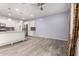 Open-concept living area with a view of the stainless steel appliances in the kitchen at 10320 E Tupelo Ave, Mesa, AZ 85212