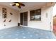 Covered patio with a ceiling fan, sliding glass door, and decorative tile flooring at 10320 E Tupelo Ave, Mesa, AZ 85212