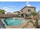 An inviting backyard includes a sparkling pool and outdoor seating, perfect for enjoying sunny days at 1061 E Poncho Ln, San Tan Valley, AZ 85143