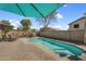 Private backyard oasis with a refreshing pool, brick patio, and lounge chairs for ultimate relaxation at 1061 E Poncho Ln, San Tan Valley, AZ 85143