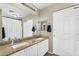 Bathroom with double sinks, granite countertops, a large mirror, and ample cabinet space at 1061 E Poncho Ln, San Tan Valley, AZ 85143