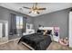 This stylish bedroom is bathed in natural light and features cool gray walls, a vanity, and an upholstered bed at 1061 E Poncho Ln, San Tan Valley, AZ 85143