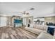 Spacious living room with modern wood flooring and an entertainment center, open to the kitchen at 1061 E Poncho Ln, San Tan Valley, AZ 85143