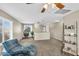 Open-concept living room features modern furniture and a large window that brings in ample natural light at 1061 E Poncho Ln, San Tan Valley, AZ 85143