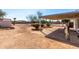 A backyard features desert landscaping, a covered patio, and plenty of open space at 1061 S Palo Verde St, Mesa, AZ 85208