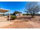 Backyard with desert landscaping, a covered patio, and two storage sheds at 1061 S Palo Verde St, Mesa, AZ 85208