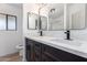 This bathroom has a double vanity with granite countertops, dual mirrors, and black hardware at 1061 S Palo Verde St, Mesa, AZ 85208