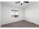 Neutral bedroom featuring carpet, a ceiling fan, and a window providing natural light at 1061 S Palo Verde St, Mesa, AZ 85208