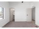 Bright bedroom features neutral carpet, white walls, large window, and access to a walk-in closet at 1061 S Palo Verde St, Mesa, AZ 85208