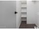 A walk-in closet with shelves and carpet, providing plenty of storage space at 1061 S Palo Verde St, Mesa, AZ 85208