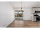 Inviting dining area with hard surface floors and backyard access with modern chandelier at 1061 S Palo Verde St, Mesa, AZ 85208