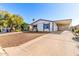 Inviting single-story home with covered parking, complemented by a low-maintenance gravel front yard at 1061 S Palo Verde St, Mesa, AZ 85208