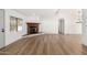 Bright, open living room with wood floors, a charming stone fireplace, and a modern light fixture at 1061 S Palo Verde St, Mesa, AZ 85208