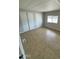 Neutral bedroom with tiled floors, sliding door closet, and large window at 10955 N 79Th N Ave # 34, Peoria, AZ 85345