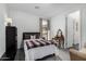 Bedroom with dark wood bed frame, vintage vanity and side table with modern lighting at 11366 W Ashby Dr, Peoria, AZ 85383