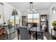 Elegant dining room with a modern chandelier, stylish chairs, and a view of the outdoor landscape at 11366 W Ashby Dr, Peoria, AZ 85383